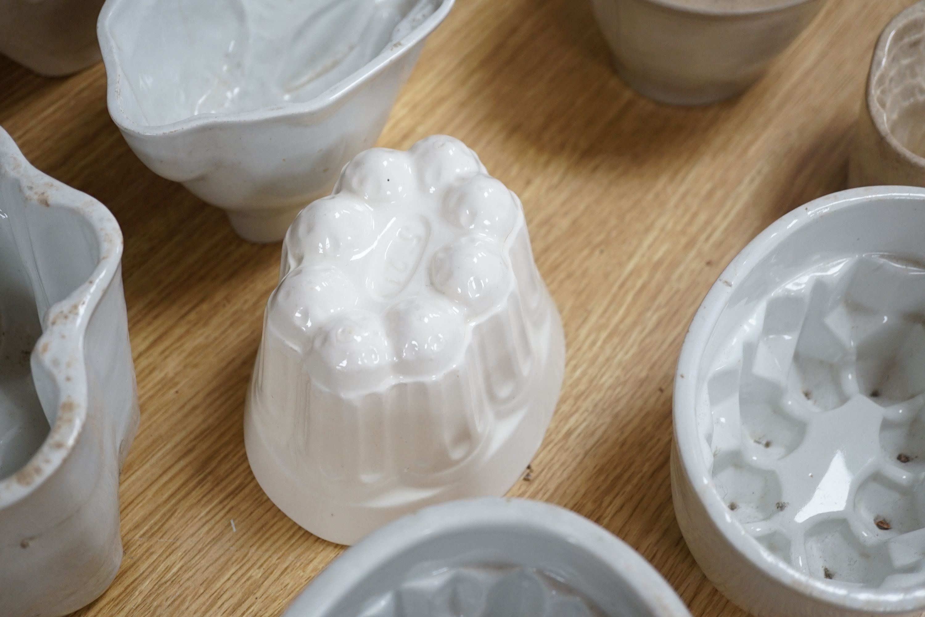 A collection of thirteen various sized 19th and 20th century ceramic jelly moulds